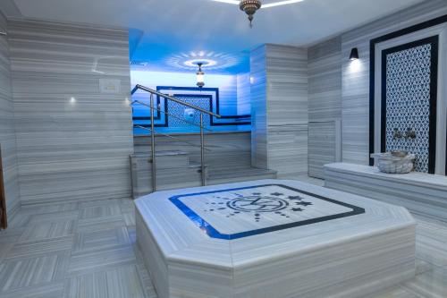 a room with a staircase and a bed in it at Royal Capital Thermal & Spa Hotel in Bursa