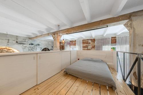 a bedroom with a bed in the middle of a room at Raw Luxury Loft in Vilnius in Vilnius