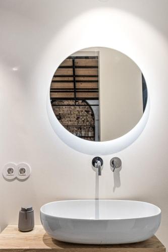 a bathroom with a sink and a mirror at Raw Luxury Loft in Vilnius in Vilnius