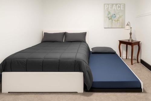 a bedroom with a bed and a side table at Mountain Views - Peaceful Retreat - 1BR suite in Sooke