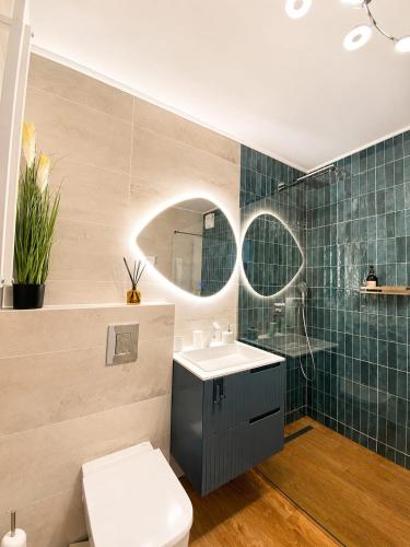 a bathroom with a sink and a toilet and a mirror at CBN Cabana in Muntele Cacovei