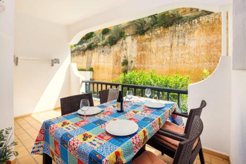 a table with a table cloth on a balcony at Casa Sem Pressa - Beach, Pool & Central Carvoeiro in Carvoeiro