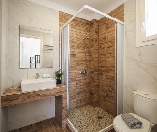 a bathroom with a shower with a sink and a toilet at Mare Naxia Hotel in Naxos Chora