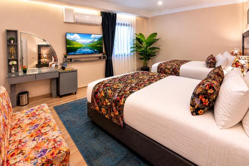 a hotel room with two beds and a television at Bond Hotel in Istanbul