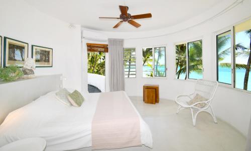 a bedroom with a bed and a ceiling fan at Villa Eva in Belle Mare