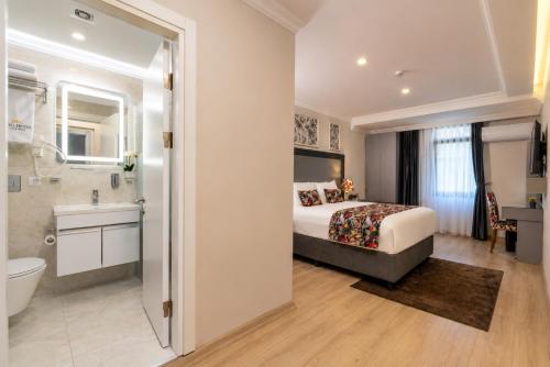 a bedroom with a bed and a bathroom at Bond Hotel in Istanbul