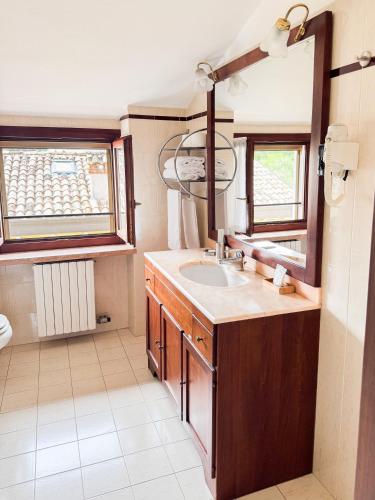 a bathroom with a sink and a mirror at Apartments Colombara Bardolino in Bardolino