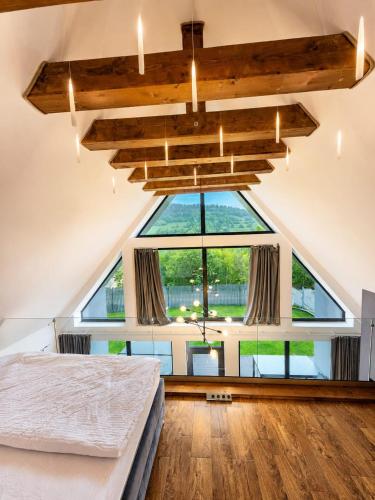 a bedroom with a large window and a bed at CBN Cabana in Muntele Cacovei