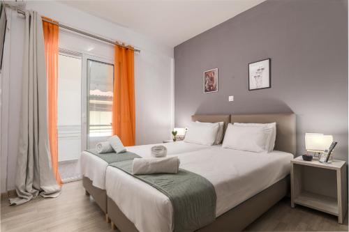 a bedroom with a large bed and a large window at ΤΗΕRAMVOS in Pefkochori