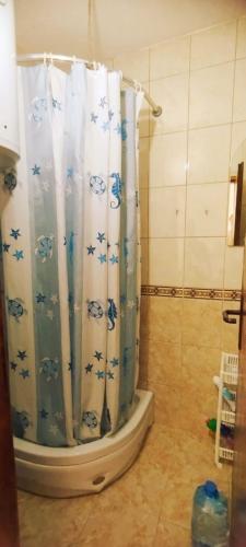 a bathroom with a shower curtain with stars on it at Oasis - Oaza in Sutomore