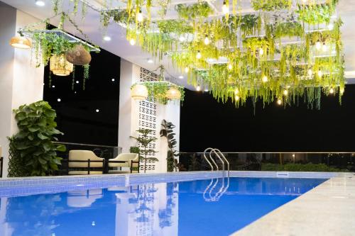 a hotel with a pool and a chandelier at Cambana Poipet Hotel in Krong Poi Pet