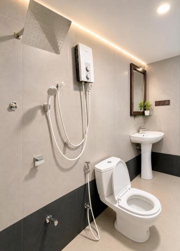 a bathroom with a shower and a toilet and a sink at Nature Lounge in Udawalawe