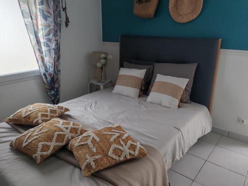 a bed with pillows on it in a bedroom at Studio pour 1 ou 2 personnes in Le Landreau