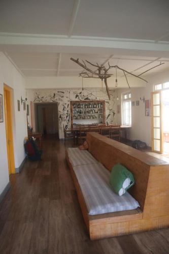 a living room with a couch with a pillow on it at Laughing Leopard Hostel in Nuwara Eliya