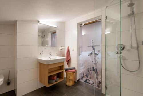 a bathroom with a sink and a shower at Klausnerhof in Aschau