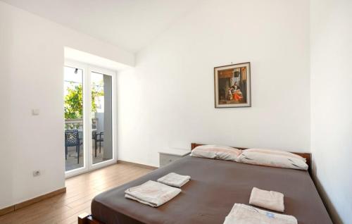 a bedroom with a bed and a large window at Apartments Bašić Pirovac - Sea view - Small and large groups in Pirovac
