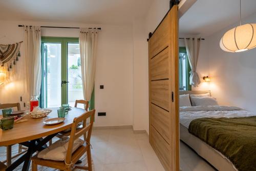 a bedroom with a bed and a table and a desk at Asini deluxe suite 1, with rooftop terrace and breathtaking views in Asíni