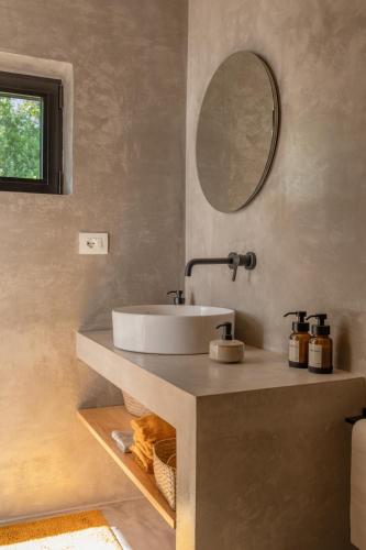 a bathroom with a sink and a mirror at Casa Pavone in Carovigno