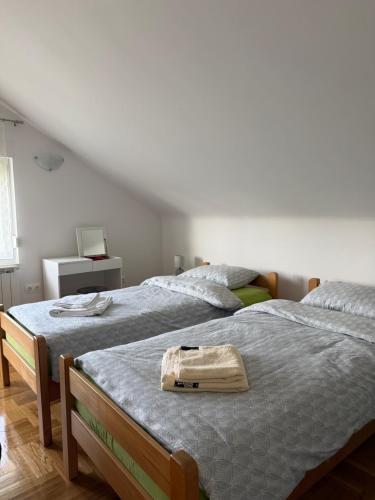 a bedroom with two beds with a bag on the bed at Mare in Generalski Stol