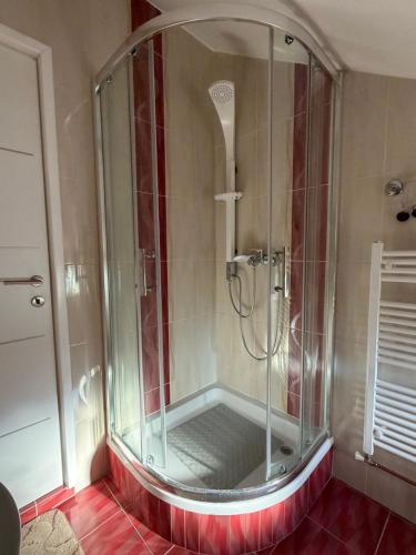 a shower with a glass enclosure in a bathroom at Mare in Generalski Stol