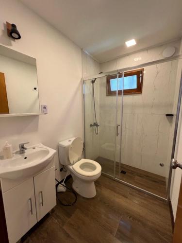 a bathroom with a shower and a toilet and a sink at Mauruuru in La Pedrera