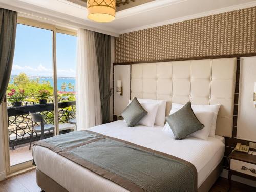 a bedroom with a large bed and a large window at Trend Park Hotel in Antalya