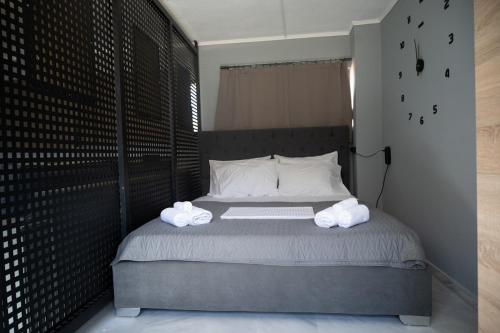 a bedroom with a bed with two towels on it at Rooftop View Chios in Chios