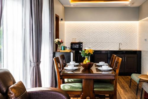 a dining room with a wooden table and chairs at Arterra Haven , Aonang Krabi in Ao Nang Beach