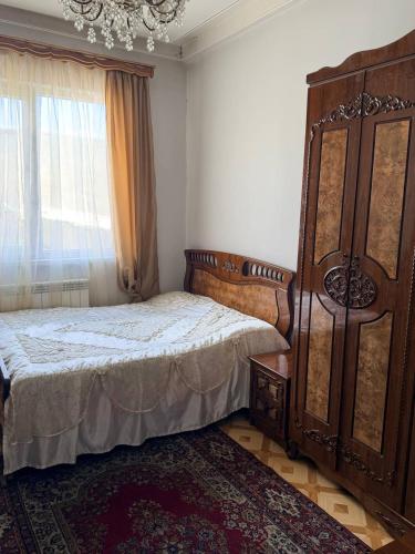 a bedroom with a large bed and a window at holiday house in Gavarr