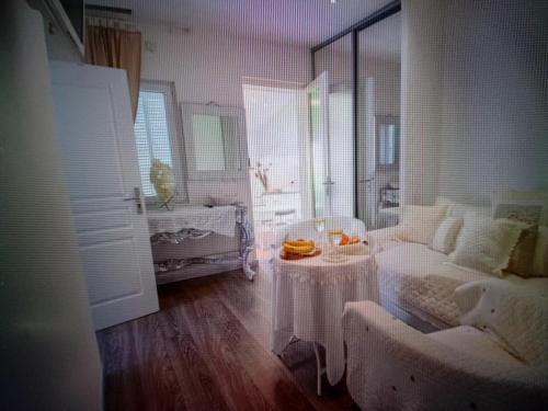 a living room with a couch and a table in it at Chic Villa Webb Cannes in Cannes