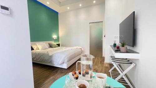 a bedroom with a bed and a table with food on it at Alloggio degli Eroi by LocazioniOK in Mola di Bari