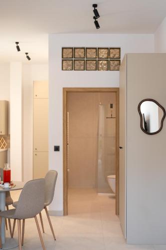 a bathroom with a table and chairs and a toilet at Asini deluxe suite 3, with rooftop terrace and breathtaking views in Asíni