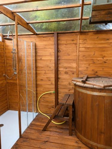 a sauna with a wooden tub and a wooden chair at AGROTURYSTYKA POD ŚNIEŻNĄ in Bystrzyca Kłodzka