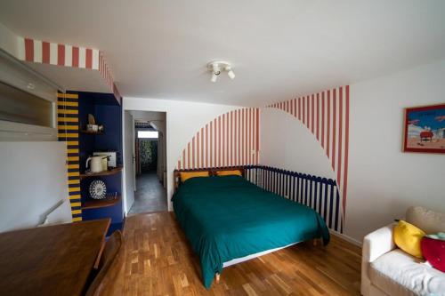 a bedroom with a bed and a couch at Stripe Studio in Bonne-sur-Ménoge