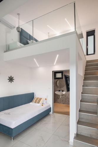a bedroom with a bed and a staircase with a stair case at Mini Boutique Dragani in Sykia Chalkidikis