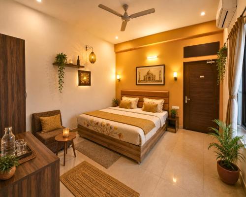 a bedroom with a bed and a chair in it at The Hideout Agra Garden Homestay - Near Taj Mahal in Agra