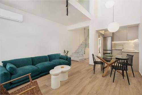 a living room with a green couch and a table at No7 Pool House in Iraklitsa