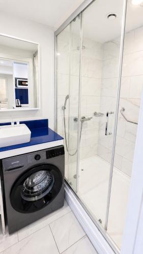 a washing machine in a bathroom with a shower at The Infinity Panorama Batumi in Batumi
