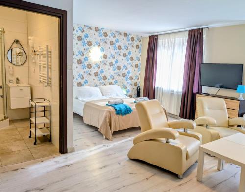 a bedroom with a bed and a living room at PATIO dom gościnny in Łukęcin