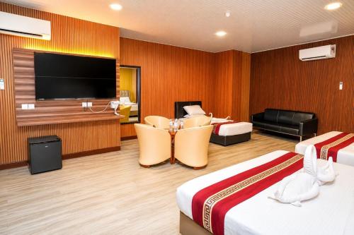 a hotel room with two beds and a flat screen tv at SS Hotel Seremban in Seremban