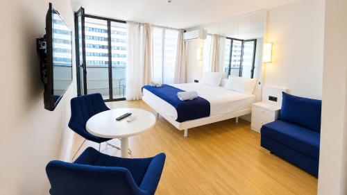 a hotel room with a bed and a table and chairs at The Infinity Panorama Batumi in Batumi