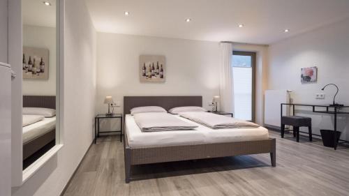 a bedroom with a bed and a desk in it at exNicrum Wein . Genuss . Hotel in Hessigheim