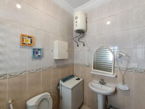 a bathroom with a toilet and a sink at الامتياز in Jeddah