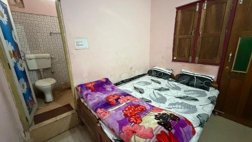 a small room with a bed in a bathroom at Hotel Akshni Palace in Pūrnia