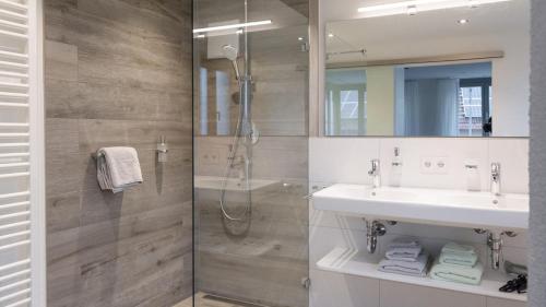a bathroom with a shower and a sink at exNicrum Wein . Genuss . Hotel in Hessigheim