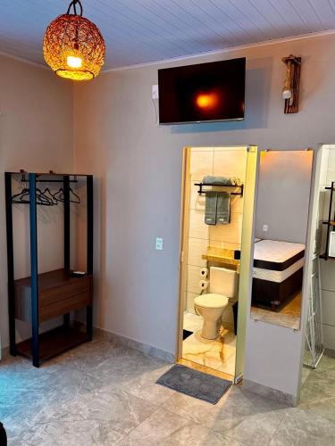 a room with a bathroom with a toilet and a sink at Pousada Imperio Azul in Santo Amaro