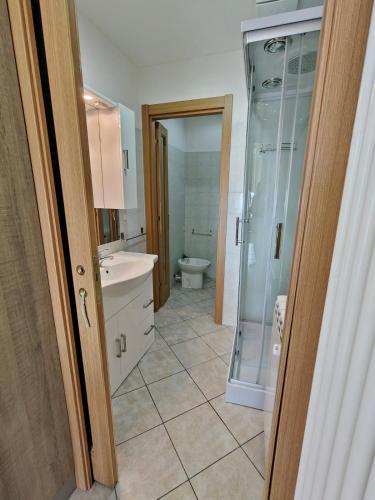 a bathroom with a glass shower and a toilet at Garibaldi 39 in Loano