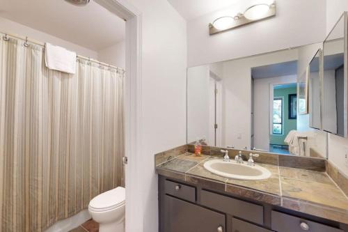 a bathroom with a sink and a toilet and a mirror at Discovery 4 162 in Mammoth Lakes