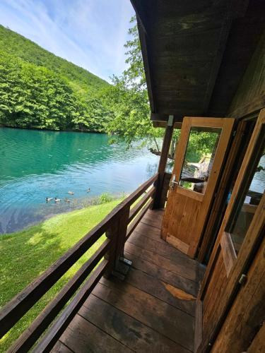 a door to a cabin with a view of a lake at Kamp SAN in Zaglavica