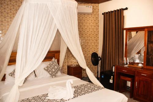 a bedroom with a bed with a canopy at Adyara Homestay in Sidemen